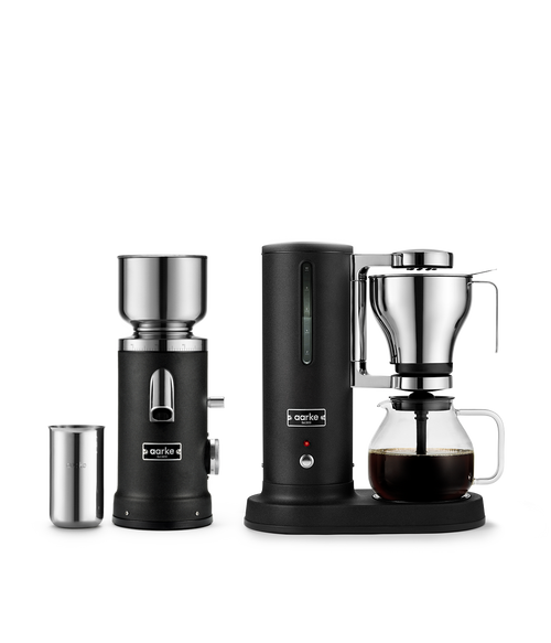 Aarke Coffee Maker and Coffee Grinder in Matte Black with stainless steel accessories and freshly brewed filter coffee.