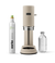 Aarke Carbonator Pro in Sand with a 100% renewable CO2 cylinder and glass bottle filled with sparkling water.