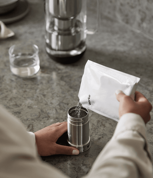 Adding Aarke Filter Granules to the Aarke Water Purifier filter cartridge in stainless steel.