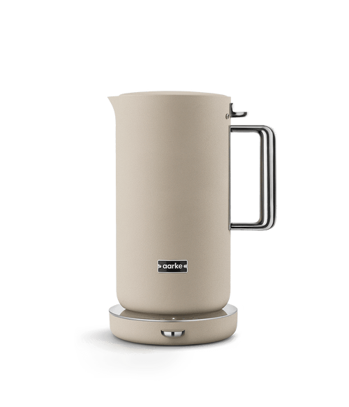 AARKE Kettle Sand electric kettle with stainless steel handle, shown on base in a minimalist Scandinavian design.