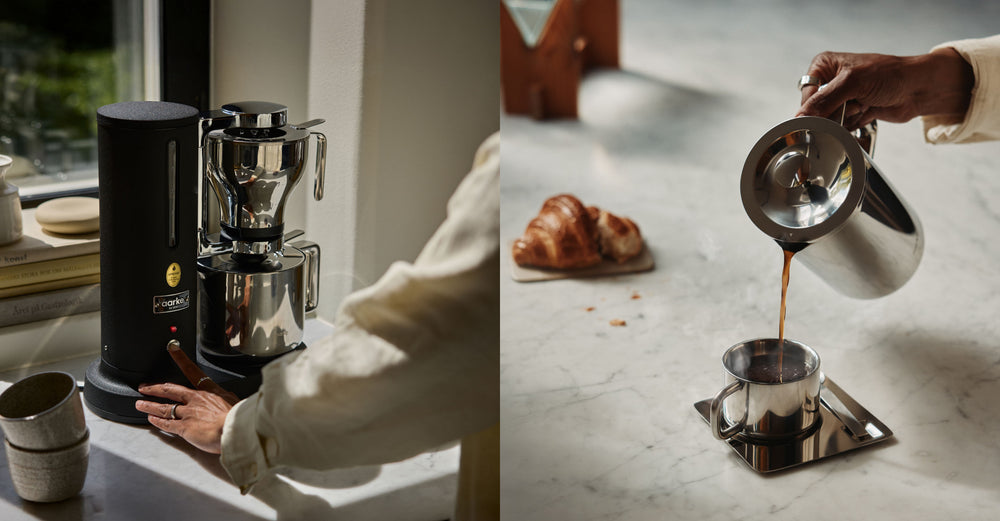 Coffee machine on a kitchen counter with a person pouring coffee into a cup using the french press.