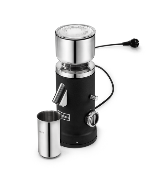 Aarke Coffee Grinder in Matte Black with stainless steel bean hopper and coffee grounds cup, viewed from an angle.